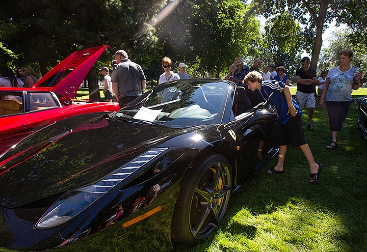 &lt;p&gt;TESS FREEMAN/Press&lt;/p&gt;&lt;p&gt;Ronan Malaghan, 11, of Coeur d&#146;Alene looks at a 2013 458 Spider Ferrari at the &#147;Ferarris in the Park&#148; event.&lt;/p&gt;