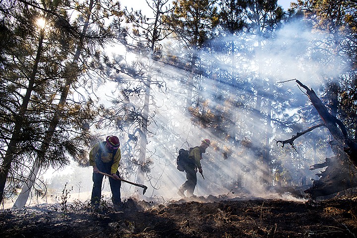 &lt;p&gt;TESS FREEMAN/Press&lt;/p&gt;&lt;p&gt;Sheldon Dissinger&#160;and Travis Hixson&#160;of the Idaho Department of Lands&#160;extinguish a grass fire that started next to the Centennial Trail alongside I-90 on Tuesday afternoon.&lt;/p&gt;