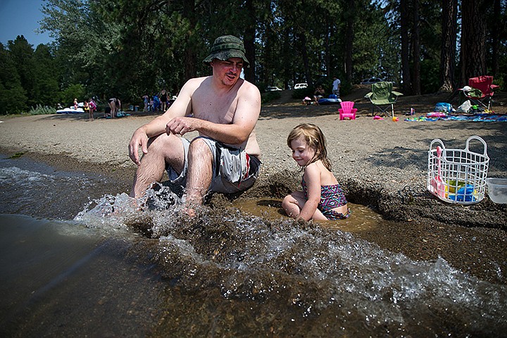 &lt;p&gt;TESS FREEMAN/Press&lt;/p&gt;&lt;p&gt;Gabe Wright&#160;and his daughter Maggie Wright, 3,&#160;play in the Spokane River on Wednesday afternoon. Temperatures reached a high of 99 degrees Wednesday in Coeur d&#146;Alene.&lt;/p&gt;