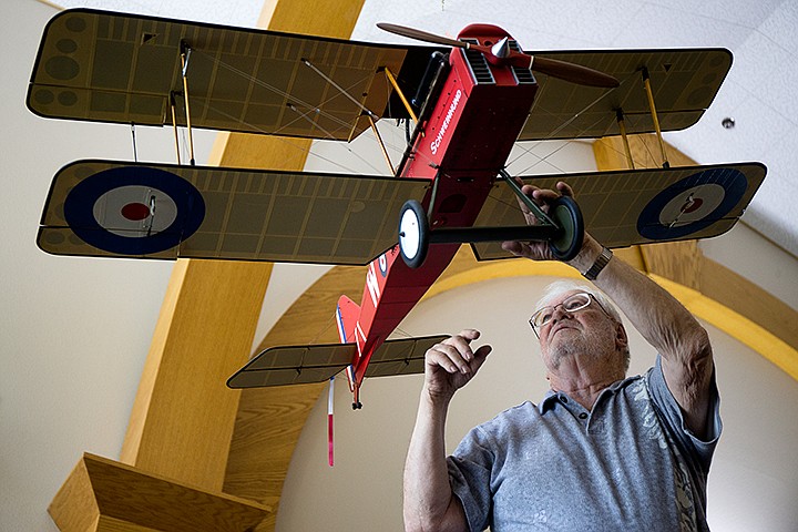 &lt;p&gt;TESS FREEMAN/Press&lt;/p&gt;&lt;p&gt;Stan Allison of Coeur d'Alene&#160;hangs his WWI SE-5a model plane which was piloted by Duncan William Grinnell-Milne of the Royal Flying Corps in the Post Falls Library on Wednesday morning. Allison is president and aircraft builder of the Coeur d'Alene Aero Modeling Society (CAMS) and donated his two model planes to promote the Pilot Project on July 24th and an air show at the CAMS airfield on July 26.&lt;/p&gt;