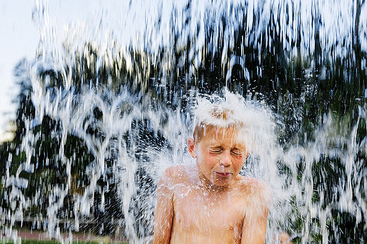 &lt;p&gt;SHAWN GUST/Press&lt;/p&gt;&lt;p&gt;Christian Schmidt, 8, is drenched by a flood of water as it falls from a splash pad feature above his head while seeking reprieve from temperatures in the 90s Monday afternoon at McEuen Park in Coeur d&#146;Alene.&lt;/p&gt;