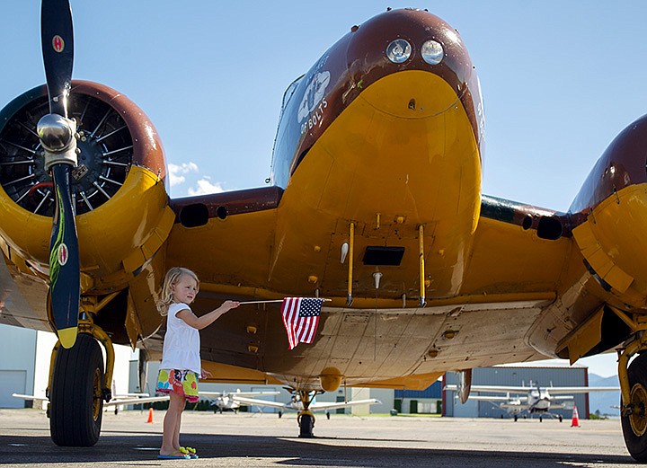 &lt;p&gt;MIKE CURRY/Press&lt;/p&gt;&lt;p&gt;Mckenna Wilson, 3, of Coeur d&#146;Alene, holds an American flag while wandering around the underside of a C-45 airplane.&lt;/p&gt;