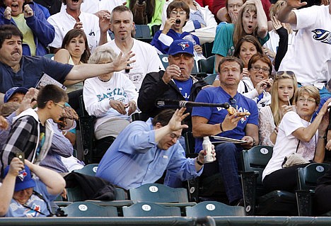 &lt;p&gt;A fan tries to shield himself from a bat that flew from the hands of Toronto Blue Jays' Edwin Encarnacion against the Seattle Mariners in the first inning of a baseball game, Tuesday, July 31, 2012, in Seattle. (AP Photo/Elaine Thompson)&lt;/p&gt;