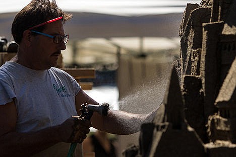 &lt;p&gt;Scott Dodson lightly sprays a section of an 11-foot-tall sandcastle during Art on the Green on NIC's campus on Friday afternoon.&lt;/p&gt;