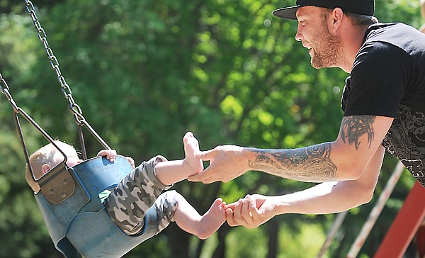 &lt;p&gt;Robert Walker of Dutch Harbor, Alaska, plays with his
one-year-old son Riley on Monday afternoon at Woodland Park. The
family is in Kalispell visiting family over the summer break.&lt;/p&gt;