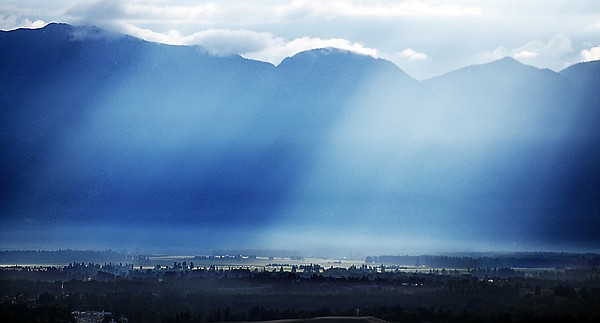 &lt;p&gt;Early morning light streams through dense clouds over the Swan
Mountain Range on Wednesday morning east of Kalispell.&lt;/p&gt;