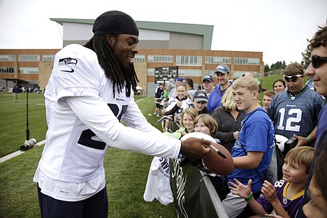 &lt;p&gt;Seattle Seahawks cornerback Richard Sherman signs autographs during NFL football training camp, Monday, July 30, 2012, in Renton, Wash. (AP Photo/Ted S. Warren)&lt;/p&gt;