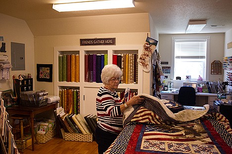 &lt;p&gt;Jerene Kindley, Coordinator of the North Idaho Quilts of Valor unfolds a quilt in the workshop where they work on all there quilts that they will present to veterans of war.&lt;/p&gt;