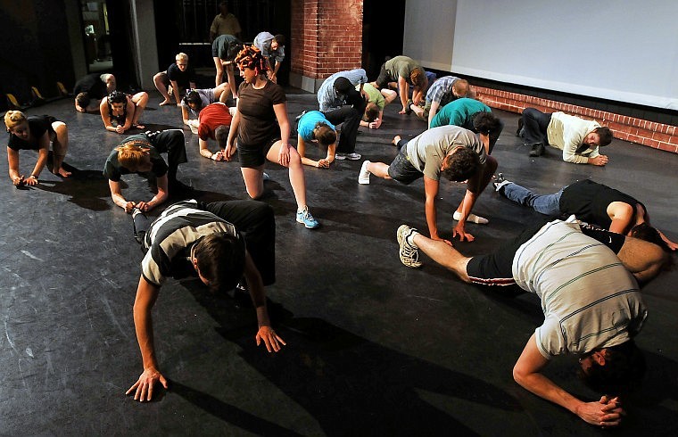 Members of the Bigfork Summer Playhouse acting company stretch prior to a performance.