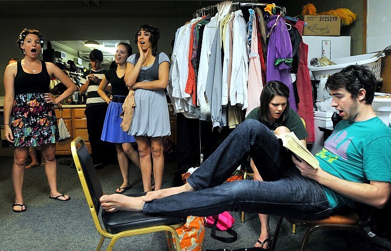 Quinn Butterfield reads a book while warming up his voice with, from left to right, Tayler Mettra, Ethan Carpenter (on phone), Nikki Spies, Kelly Hogan and Mary Raines Battle.