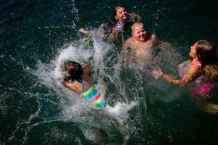 &lt;p&gt;JEROME A. POLLOS/Press Karlee Marrero, 8, dives into the water at Honeysuckle Beach and splashes her friends Emily Duncan, 10, right, Andrew Johnson, 9, and Kari Greenbank, 10, during an outing Thursday to Hayden Lake with the Quest Summer Camp from the Coeur d'Alene Church of the Nazarene.&lt;/p&gt;