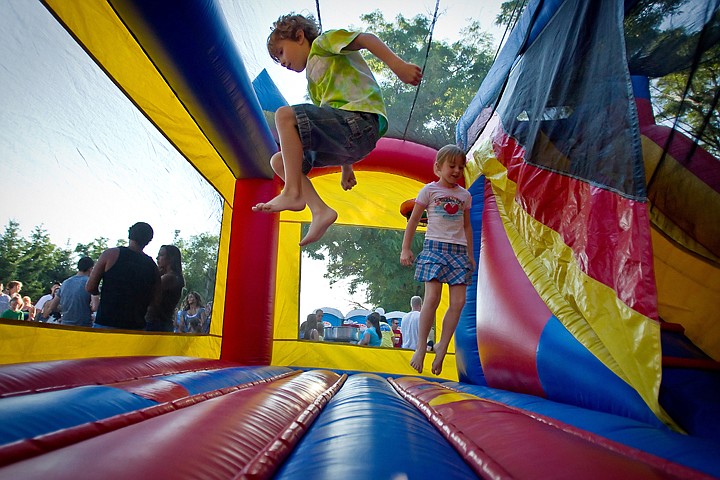 &lt;p&gt;JEROME A. POLLOS/Press Tyler Arnone, and Zoey Hippach, both 7, take advantage of the Fun Guy's bounce house at the 30th annual Body by Scotty block party Friday in Post Falls. The event featured live music, free drinks and meals as well as a car show.&lt;/p&gt;