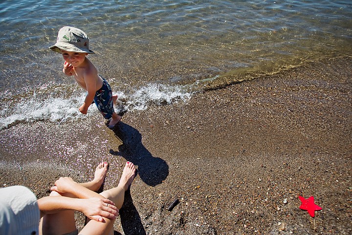 &lt;p&gt;SHAWN GUST/Press 2-year-old Calder Prussian gets his toes wet as his mother, K.K., sits nearby with her feet in the sand Thursday on Sanders Beach in Coeur d'Alene.&lt;/p&gt;