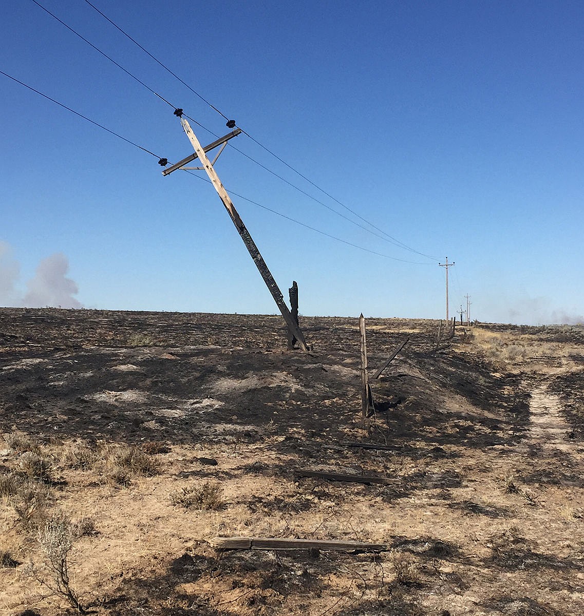 A precariously balanced electrical line shows the impact of the Black Rock Fire near Wilson Creek over the weekend.