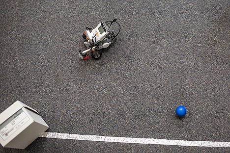 &lt;p&gt;A Lego Mindstorm robot designed by students in the University of Idaho Digital Innovators Generating New Information Technologies finds its way around an obstacle course on Friday at the University of Idaho Coeur d'Alene campus. The students had a goal of programing a robot to navigate itself inside of a ring of metal tape while dodging shoe boxes and knocking colored balls out of the tape ring's perimeter.&lt;/p&gt;