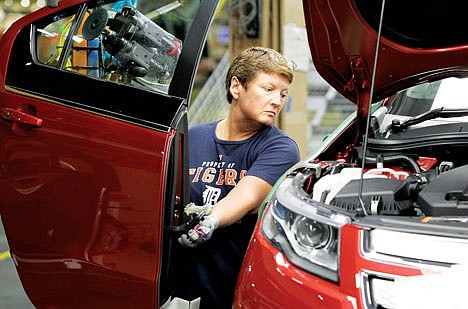 &lt;p&gt;In this July 27 photo, assembly line worker Jan Primm manuevers a door into position for a 2012 Chevrolet Volt at the General Motors Hamtramck Assembly plant in Hamtramck, Mich.&lt;/p&gt;