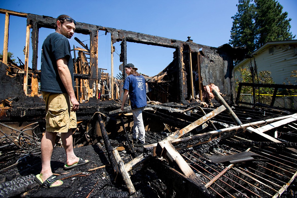 &lt;p&gt;David Evensizer and his son Sean look through the charred remains of their two-story home on Monday on Hillcrest Circle in Coeur d'Alene. The home, which the Evensizers lived in for more than six years, caught flame Sunday evening. No injuries were reported, however the family lost three pets.&lt;/p&gt;