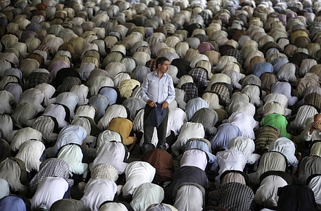 &lt;p&gt;A man stands as Iranian worshippers perform prayers during the Muslim holy fasting month of Ramadan at the Tehran University campus, in Tehran, Iran, Thursday. Muslims around the globe are observing the holy fasting month of Ramadan where they refrain from drinking, eating, smoking and sex from dawn to dusk.&lt;/p&gt;