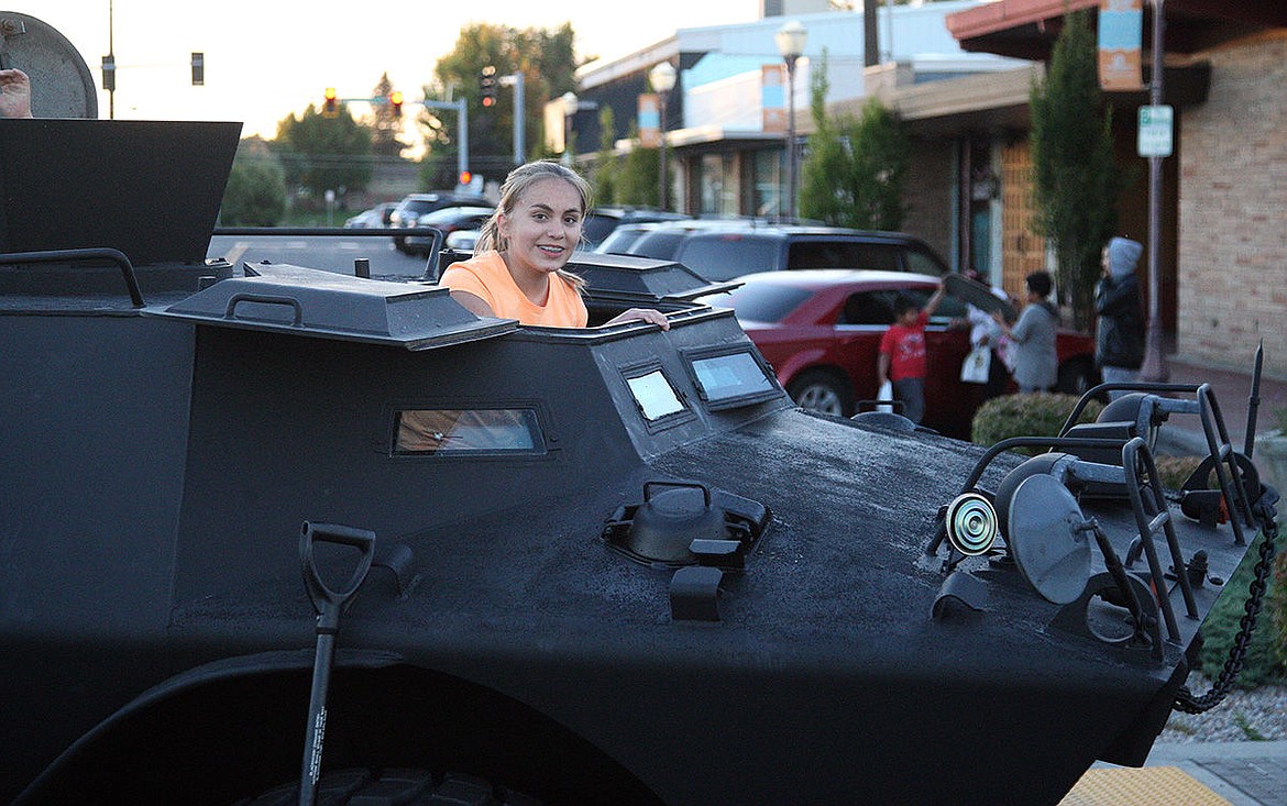 Frontier Middle School seventh-grader Emma Glencoe takes a look out the Moses Lake Tactical Response Team&#146;s V150 Armored Vehicle Tuesday night at the National Night Out celebration downtown.