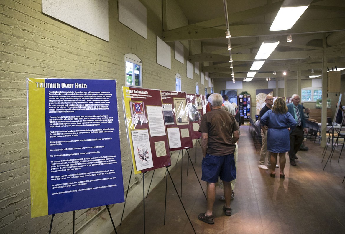 &lt;p&gt;Guests walk through the &quot;Coming Face to Face with Hate: A Search for a World without Hate&quot; exhibit during the grand re-opening of the Human Rights Education Institute Wednesday evening.&lt;/p&gt;