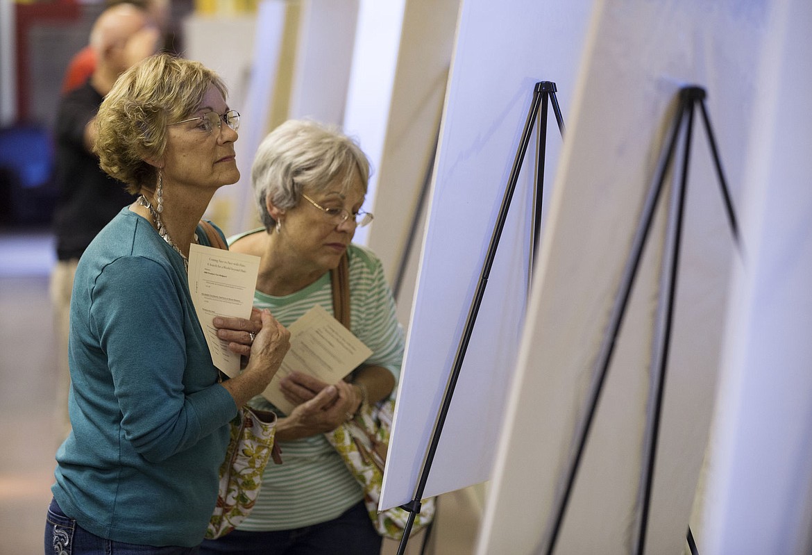 &lt;p&gt;Sisters Kay Sands, left, and Kathy Reynolds walk through the &quot;Coming Face to Face with Hate: A Search for a World without Hate&quot; exhibit during the grand re-opening of the Human Rights Education Institute Wednesday evening.&lt;/p&gt;