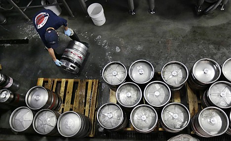 &lt;p&gt;Brewer Ken Hermann rolls a fresh keg of beer onto pallets at the Harpoon Brewery in the Seaport District of Boston on July 1.&lt;/p&gt;