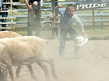 Shane Petrey, of Arlee, celebrates after riding his sheep for eight seconds during Pioneer Days last weekend in Ronan.