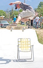 Derek Long, of Polson, clears a lawn chair during Skatejam last weekend in Polson.