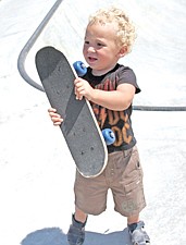 2-year-old Garret Green, of Polson, shows off his skateboard during the SkateJamlast weekend in Polson.