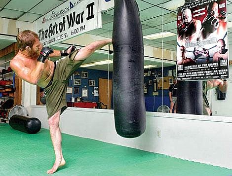 Kalispell&#146;s Brandon Olsen practices his kicks on the heavy bag to supplement his deadly ground fighting skills. Craig Moore/Daily Inter Lake