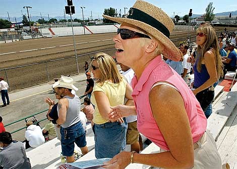 Karen Nichols/Daily Inter Lake&lt;br&gt;Kalispell horse enthusiast Cheri Brown cheers for her favorite during the horse racing Saturday at the Northwest Montana Fair. State officials are considering consolidating Montana horse racing to one track (likely in Billings), and many residents are unhappy with the idea. Brown, who rides her own horses every day, has been coming to the Kalispell horse races for 10 years.