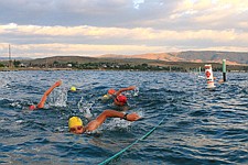 Polson&#146;s Matt Seeley leads the pack of swimmers with their brightly colored caps.