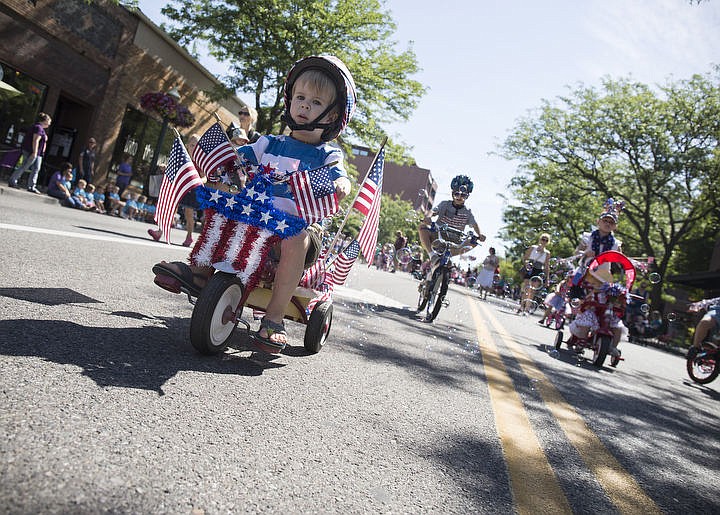 &lt;p&gt;LOREN BENOIT/Press Finn Hebener, 3, left, cycles his way down Sherman Avenue with bubbles trailing behind him during Coeur d'Alene's Kids Parade, July 1, 2016. This years parade theme was Wide World of Sports.&lt;/p&gt;