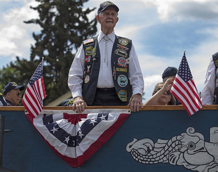 &lt;p&gt;LOREN BENOIT/Press WWII submarine veteran Tom DePew stands aboard the Honoring Submarine Veterans float as it is driven down Sherman Avenue during Coeur d'Alene's Fourth of July parade.&lt;/p&gt;