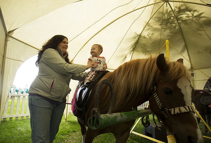 &lt;p&gt;LOREN BENOIT/Press Amanda Herfurth holds her 7-month-old daughter Qwintessa as her daughter smiles and enjoys her first ever pony ride during Hayden Days, Friday, July 22, 2016 at McIntire Family Park.&lt;/p&gt;