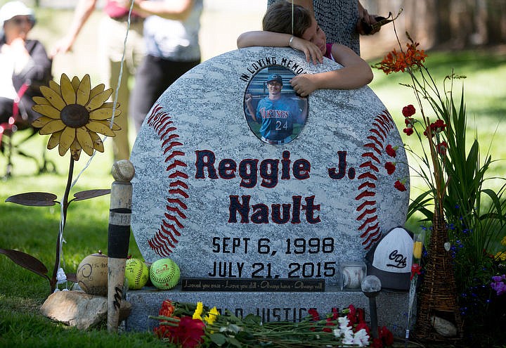 &lt;p&gt;Bella Nault, age 6, Reggie Nault's little sister, hugs his headstone at the balloon release ceremony, Thursday, in Coeur d'Alene.&lt;/p&gt;