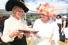 Community Bank employee, Sylvia Callantine (right), asks the bank's vice-president, Debby Olsson McClenahan, to autograph he copy of the book Olsson McClenahan authored, Community Bank: The First 100 Years, at the centennial celebration barbecue Friday in Ronan. The book, which was free to the public, chronicals the history of Community Bank and the Flathead Indian Reservation.