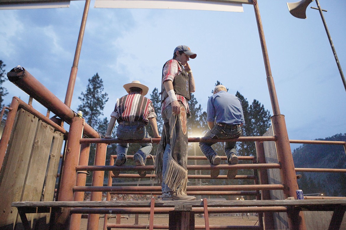 <p>Kenny Stockard, center, of Superior took his first bull ride at the 2014 Mineral County Fair.</p>