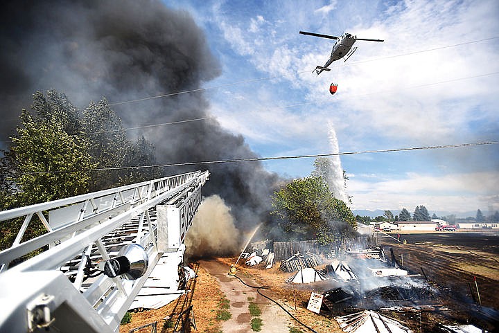 &lt;p&gt;View from atop the Evergreen Fire and Rescue ladder truck of a fire on Mountain View Drive in Evergreen on Wednesday, August 5. The helicopter is from the Department of Natural Resources and Conservation. (Brenda Ahearn/Daily Inter Lake) (Brenda Ahearn/Daily Inter Lake)&lt;/p&gt;