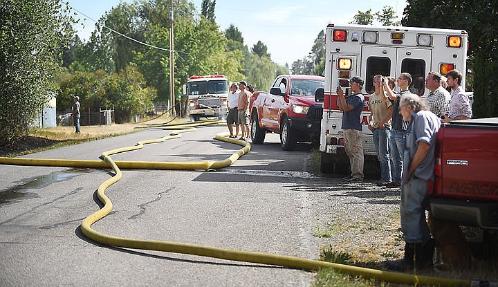 &lt;p&gt;Spectators watch the scene of a structure fire on Mountain View Drive unfold on Wednesday afternoon, August 5, in Evergreen. (Brenda Ahearn/Daily Inter Lake)&lt;/p&gt;