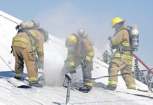 &lt;p&gt;Jason Place, left, Neil Benson and Timothy Kim at work on the house fire at 311 Idaho Sunday.&lt;/p&gt;