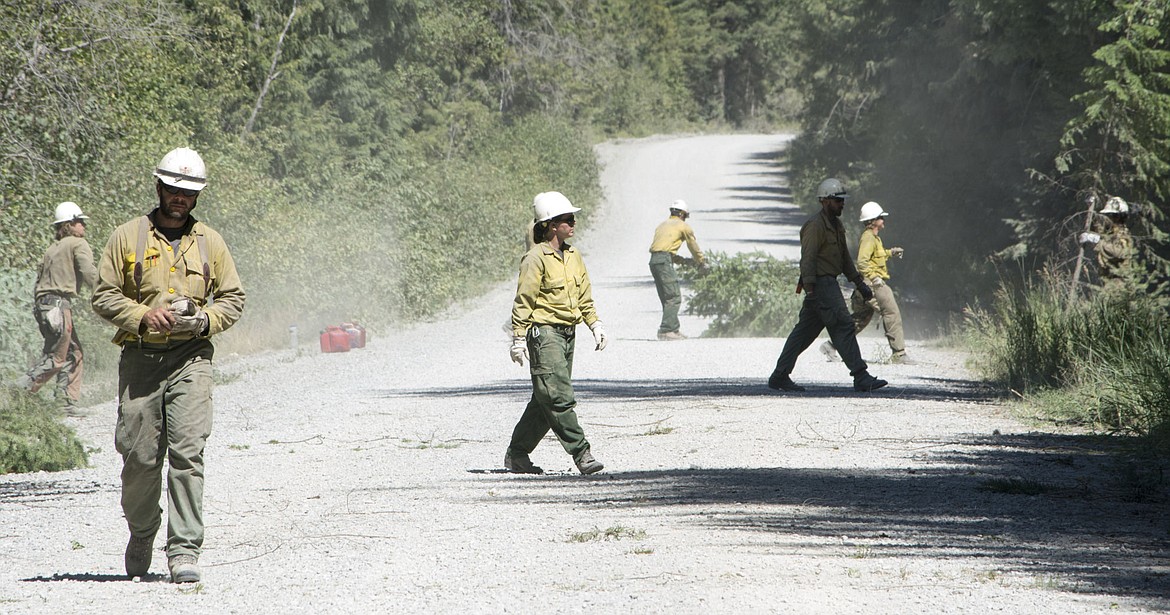 &lt;p&gt;Members of the Lolo Hot Shots work to clear the western edge of ACM road of fuel in order to perform a controlled burn on Friday night.&lt;/p&gt;