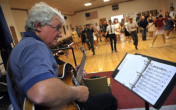 &lt;p&gt;Joel Knadler plays the guitar as dancers do the Shim Sham, a kind of line dance that is common to swing dancers, on Friday, July 20, in Kalispell.&lt;/p&gt;