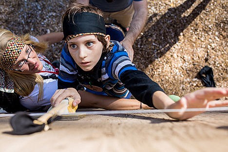 &lt;p&gt;Brian Moore, 12, reaches for a handhold on a rock climbing wall during a treasure hunt at Camp Journey, Wednesday at Ross Point Camp.&lt;/p&gt;