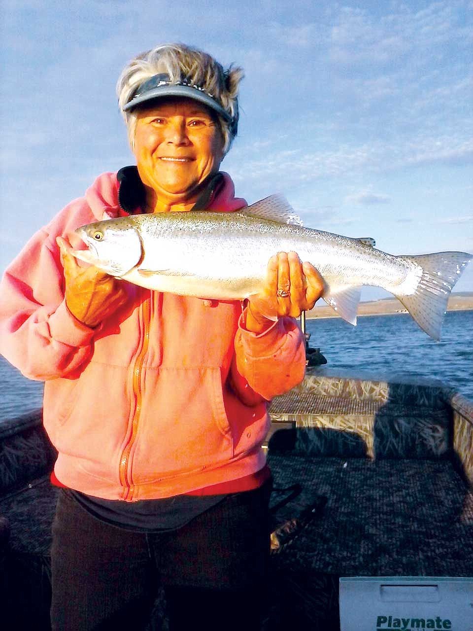 Mary Bafus with a beautiful trout caught on an early morning fishing trip.