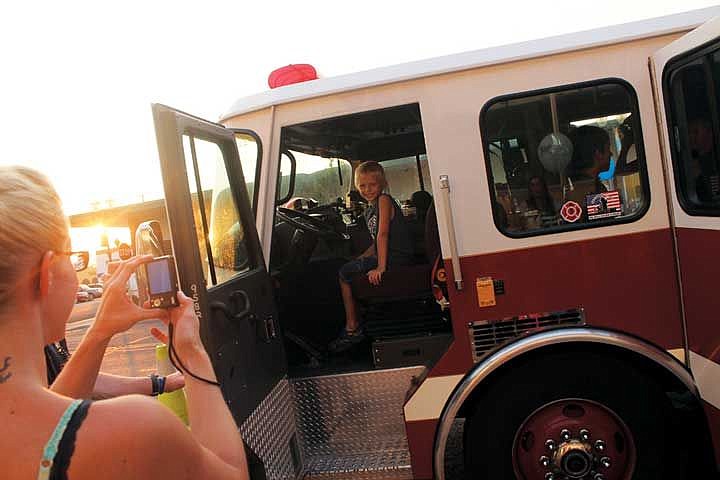 Angelo Crowell, 7, of Moses Lake, sits in the driver's seat of a firetruck during National Night Out Tuesday.