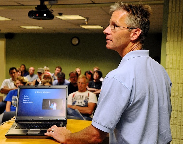 David Ports of the Missoula Family YMCA clicks through a slide presentation for a group of people at the Flathead County Library in Kalispell on Tuesday evening.