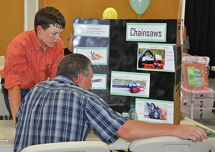 &lt;p&gt;Phillip Vaughan shows his poster describing his chainsaw project to a judge during Interview judging.&lt;/p&gt;