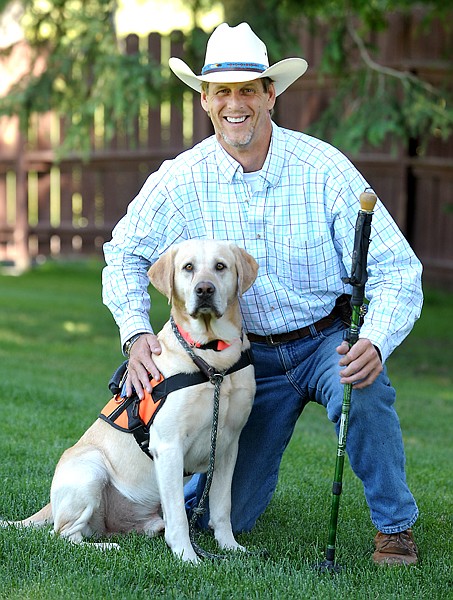 <p>David Riggs, CEO of K9 Care of Montana, is pictured with his dog, Rocky, Aug. 1 in Columbia Falls.</p>