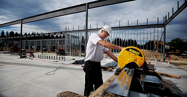 <p>Terry Riley, a carpenter with Swank Enterprises, cuts pieces for a parapet at the new Rebecca Chaney Broussard Center for Nursing and Health Science at Flathead Valley Community College on Thursday morning, August 2, in Kalispell.</p>